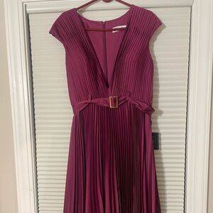 No flaws. Beautiful purple solid dress with a gold rectangular-buckle belt.